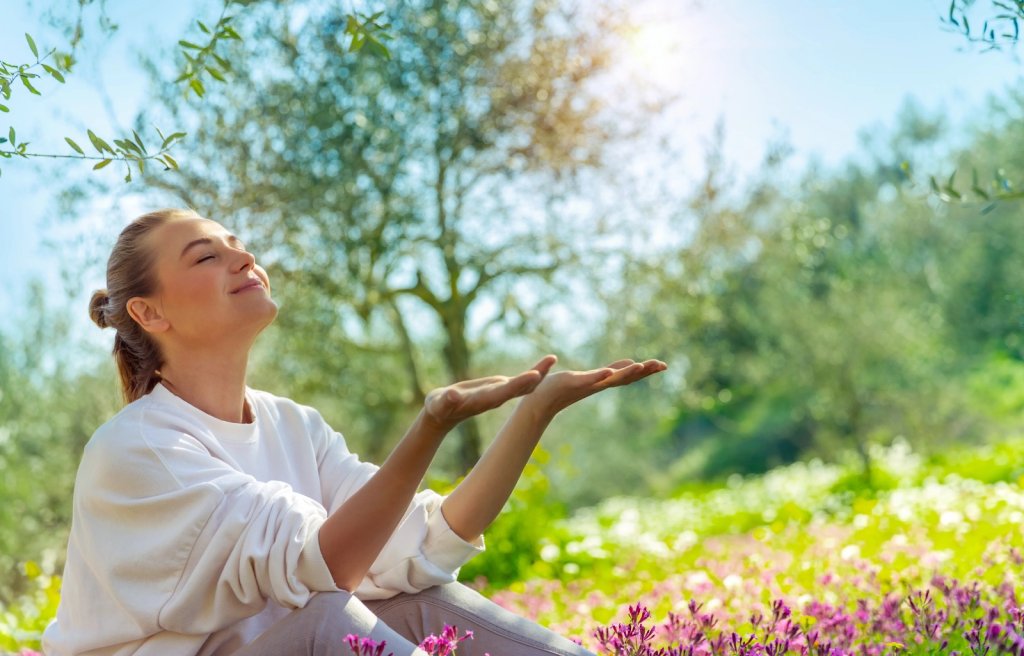 A 30 something woman bathing herself in beautiful sunlight