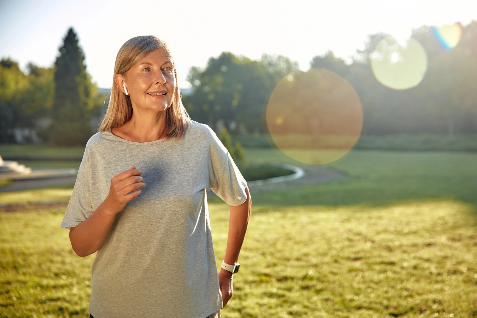 Middle-aged woman enjoying a morning walk in sunlight, symbolizing restored energy and vitality in menopause.