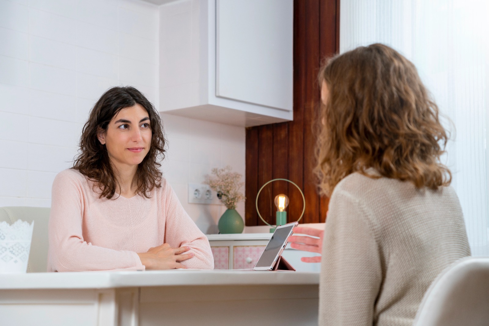 Two women discussing PCOS and PCOD symptoms during a consultation