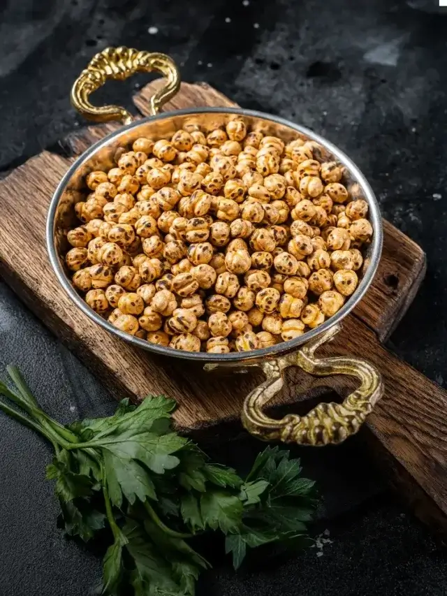 A bowl of roasted makhana on a wooden tray with natural lighting