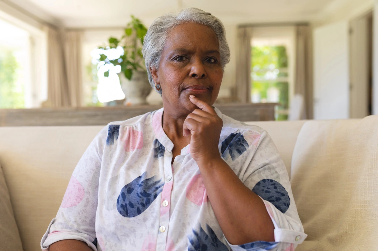 Senior woman in menopause thinking about supplements and wellness choices at home
